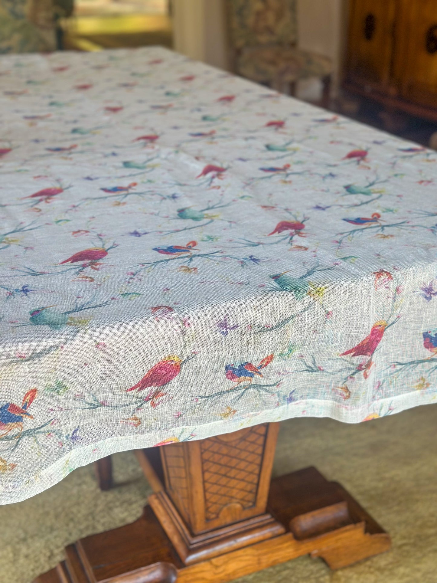 Egyptian linen tablecloth with colorful bird pattern on a wooden table