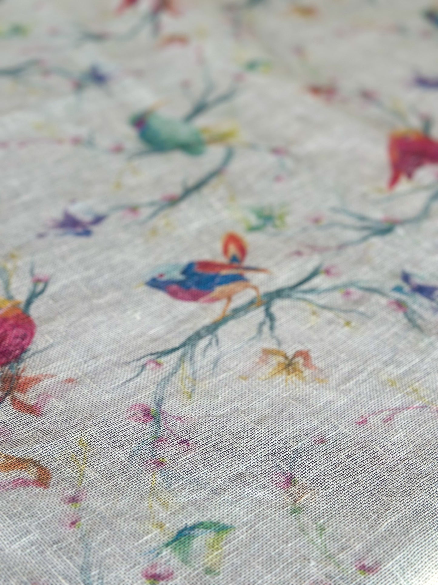Close-up of Egyptian linen tablecloth with colorful floral and bird pattern
