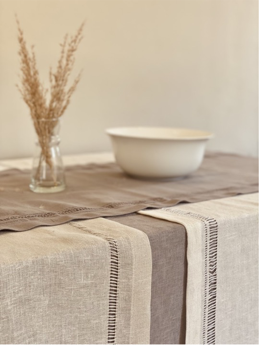 Handmade Egyptian runners draped over a dining table.