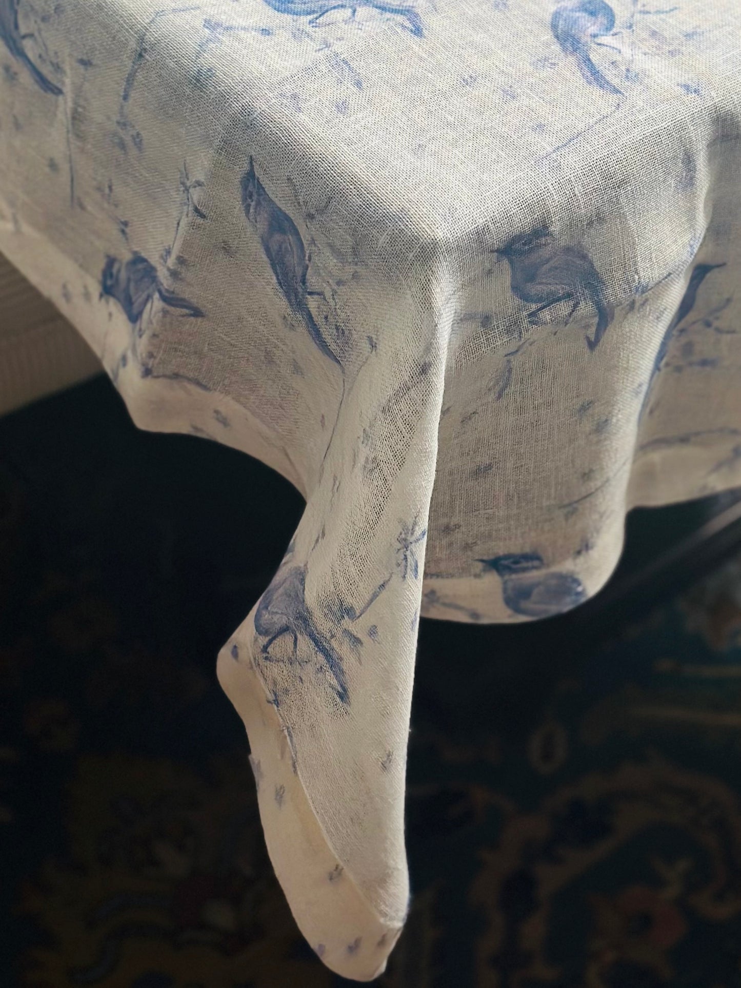 White Egyptian linen tablecloth with blue bird pattern.