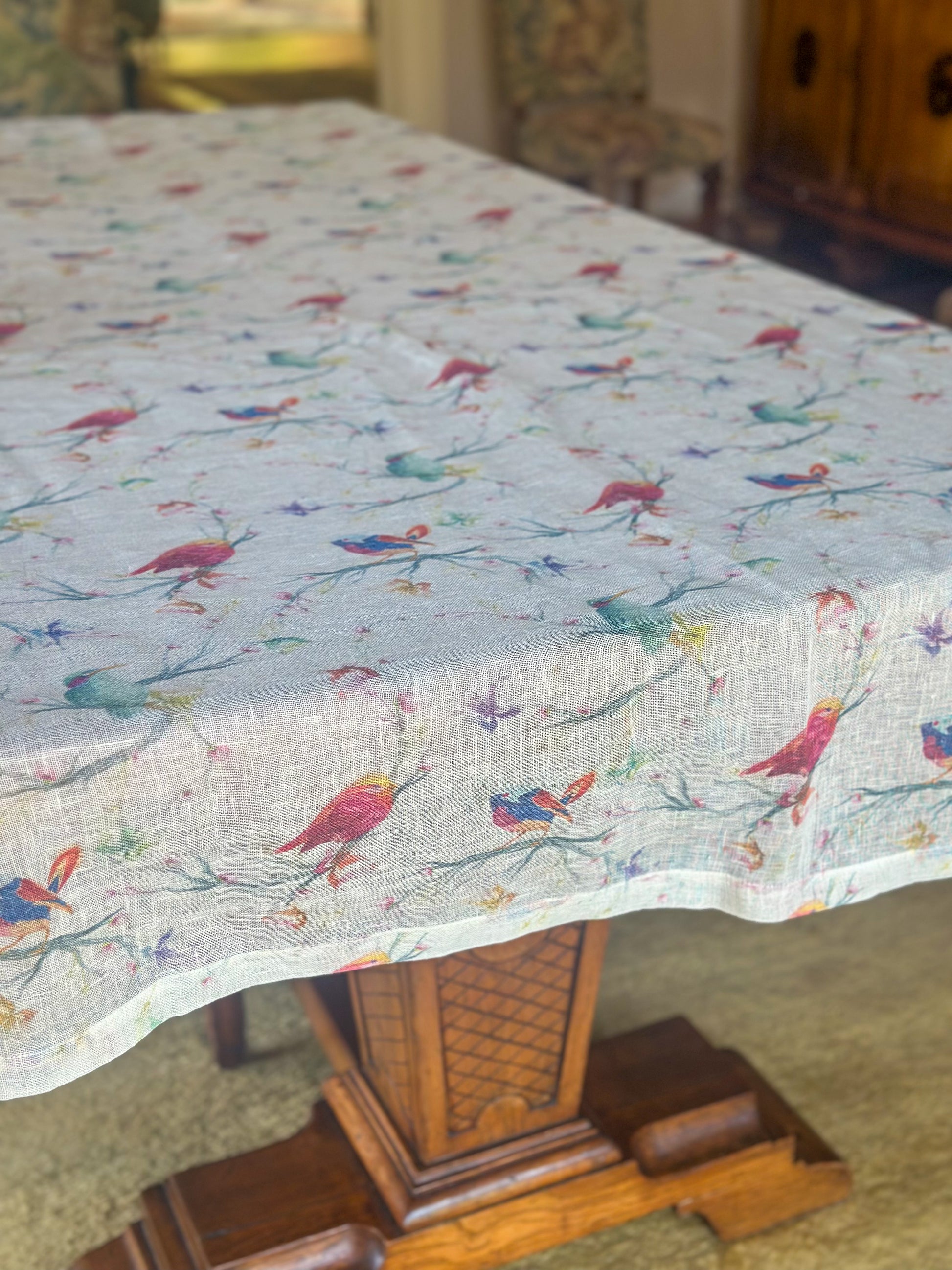 Egyptian linen tablecloth with colorful bird pattern on a wooden table